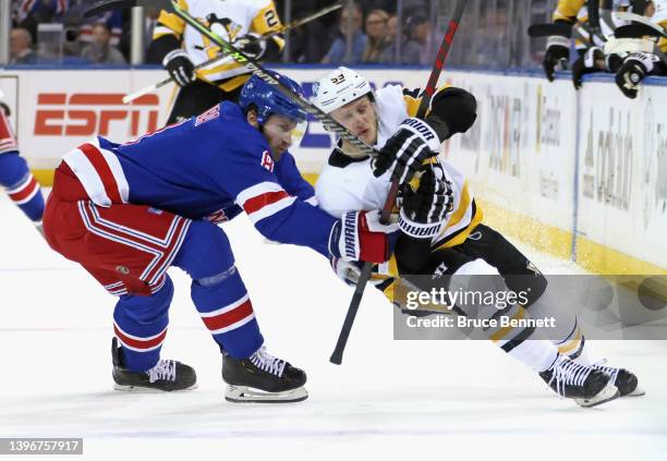 Jacob Trouba of the New York Rangers slows down Jake Guentzel of the Pittsburgh Penguins during the first period in Game Five of the First Round of...