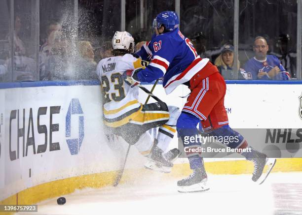 Brock McGinn of the Pittsburgh Penguins is checked into the boards by Justin Braun of the New York Rangers d1pin Game Five of the First Round of the...