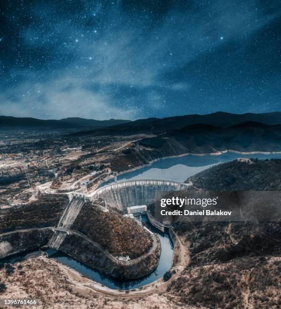 cityscape with hydroelectric dam under starry sky. sustainability. - hydroelectric power station stock pictures, royalty-free photos & images