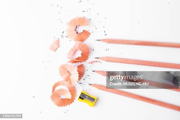 pencils with sharpening shavings on white background - pencil shavings stock pictures, royalty-free photos & images