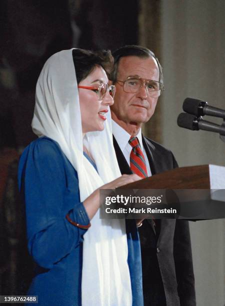 Pakistani Prime Minister Benazir Bhutto and United States President George H.W. Bush stand together to deliver remarks in the East Room of the White...