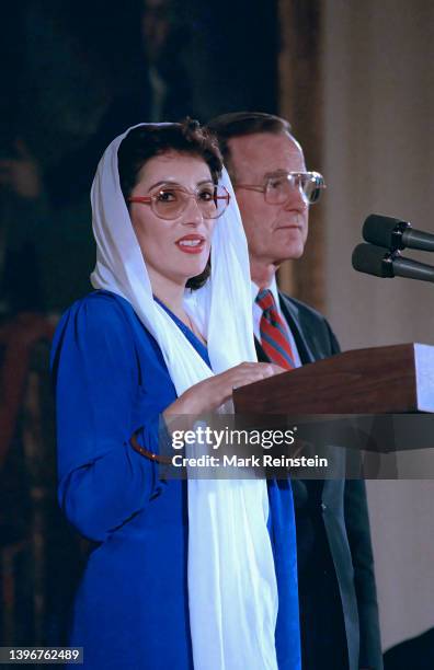 Pakistani Prime Minister Benazir Bhutto and United States President George H.W. Bush stand together to deliver remarks in the East Room of the White...