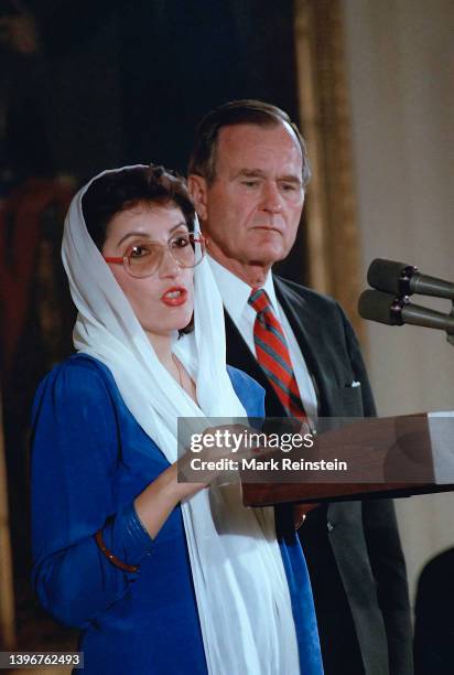 Pakistani Prime Minister Benazir Bhutto and United States President George H.W. Bush stand together to deliver remarks in the East Room of the White...