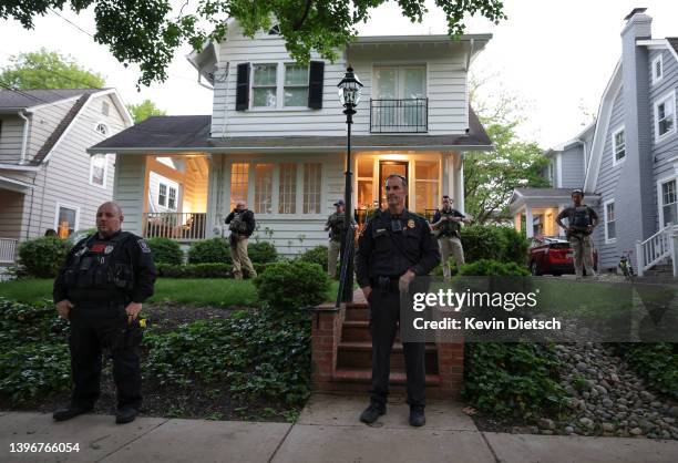 Police stand outside the home of U.S. Associate Justice Brett Kavanaugh as abortion-rights advocates protest on May 11, 2022 in Chevy Chase,...