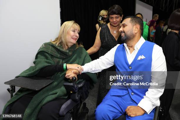Carol Taylor, designer for Christina Stephens embraces a model backstage following the Adaptive Clothing Collective show during Afterpay Australian...