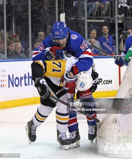Evgeni Malkin of the Pittsburgh Penguins and Ryan Lindgren of the New York Rangers tangle during the third period in Game Five of the First Round of...