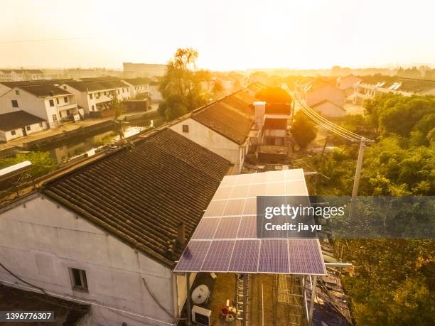 jiangyin city, jiangsu province. solar photovoltaic panels are installed on the roof of rural houses. - solar panel home stock-fotos und bilder