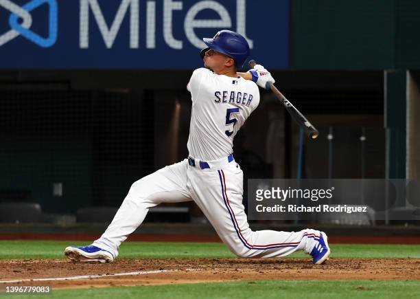 Corey Seager of the Texas Rangers follows through on his swing for a home run against the Kansas City Royals in the ninth inning at Globe Life Field...