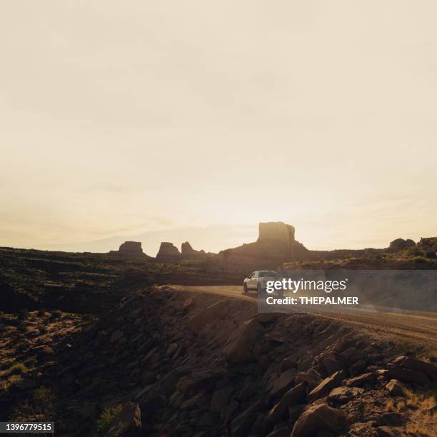 pickup truck speeding on a dirt road at sunset near to moab park, utah - pick up truck stock pictures, royalty-free photos & images