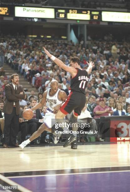 Guard Mitch Richmond of the Sacramento Kings drives past center Arvydas Sabonis of the Portland Trailblazers at the Arco Arena in Sacramento,...