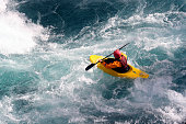 Kayaker maneuvers over rough waters 