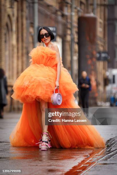 Charlene Davies wearing Giambattista Valli orange custom made dress, Bafelli purple clutch, Bally sunglasses and Culturesse earrings at Afterpay...