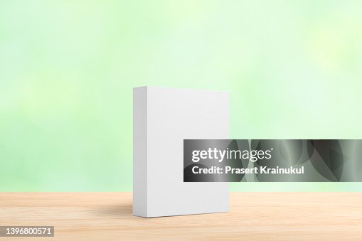 White rectangular box on table with green background White rectangular box on table with green background