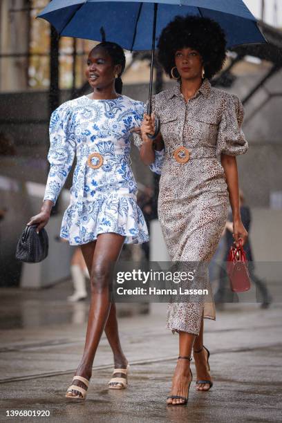 Aiyana Alexander Torannce leopard dress and Malaan Ajang Torrance blue mini dress at Afterpay Australian Fashion Week 2022 on May 12, 2022 in Sydney,...