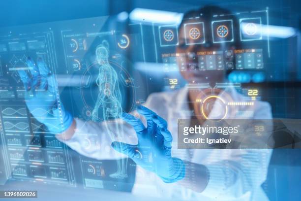 a young african-american female scientist working with hud in a modern laboratory - healthcare and medicine future stock pictures, royalty-free photos & images