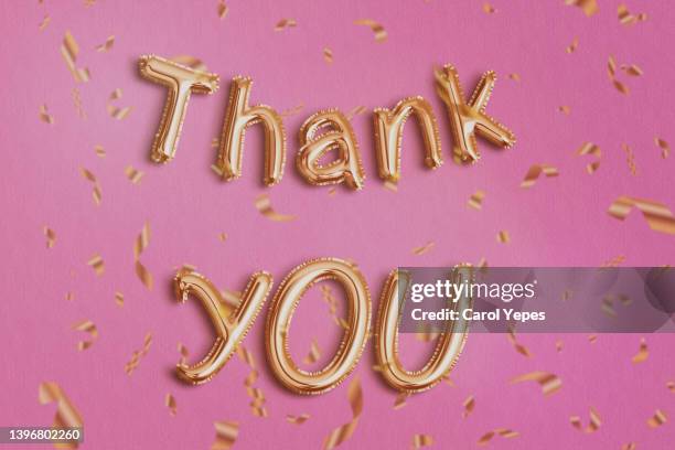 thank you in golden foil ballon.pink background - grazie foto e immagini stock