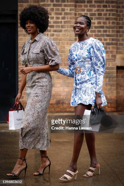 Aiyana Alexander Torannce leopard dress and Malaan Ajang Torrance blue mini dress at Afterpay Australian Fashion Week 2022 on May 12, 2022 in Sydney,...