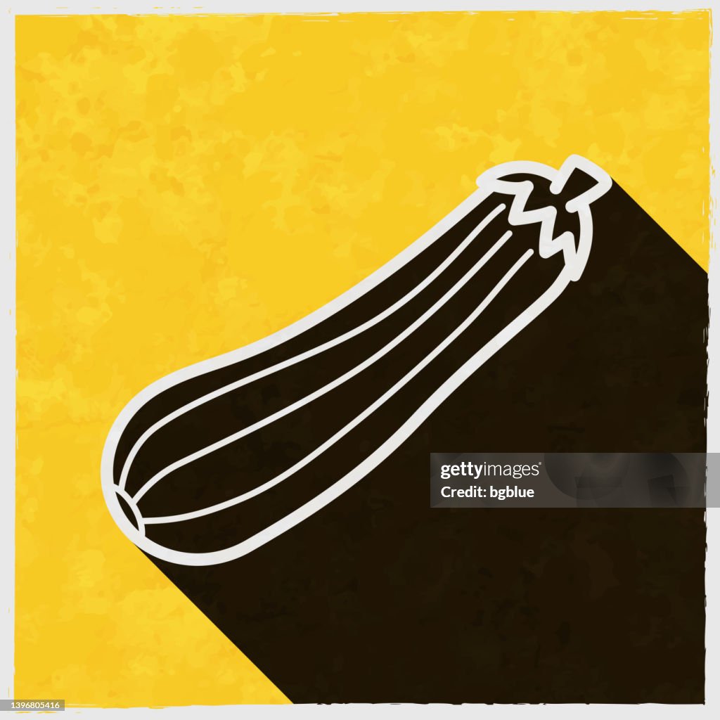 Zucchini or courgette. Icon with long shadow on textured yellow background