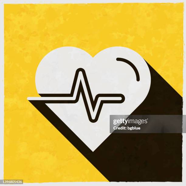 heartbeat - heart pulse. icon with long shadow on textured yellow background - pacemaker stock illustrations