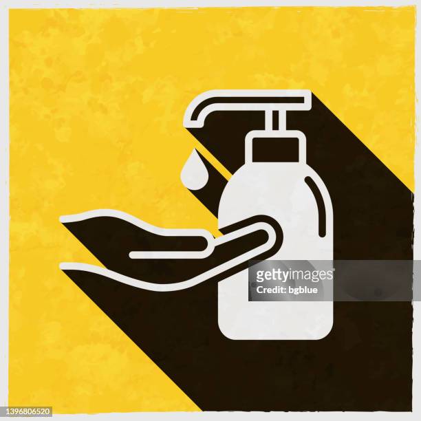 stockillustraties, clipart, cartoons en iconen met hand sanitizer use for disinfection. icon with long shadow on textured yellow background - hand sanitizer