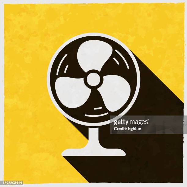 electric fan. icon with long shadow on textured yellow background - electric fan paper stock illustrations