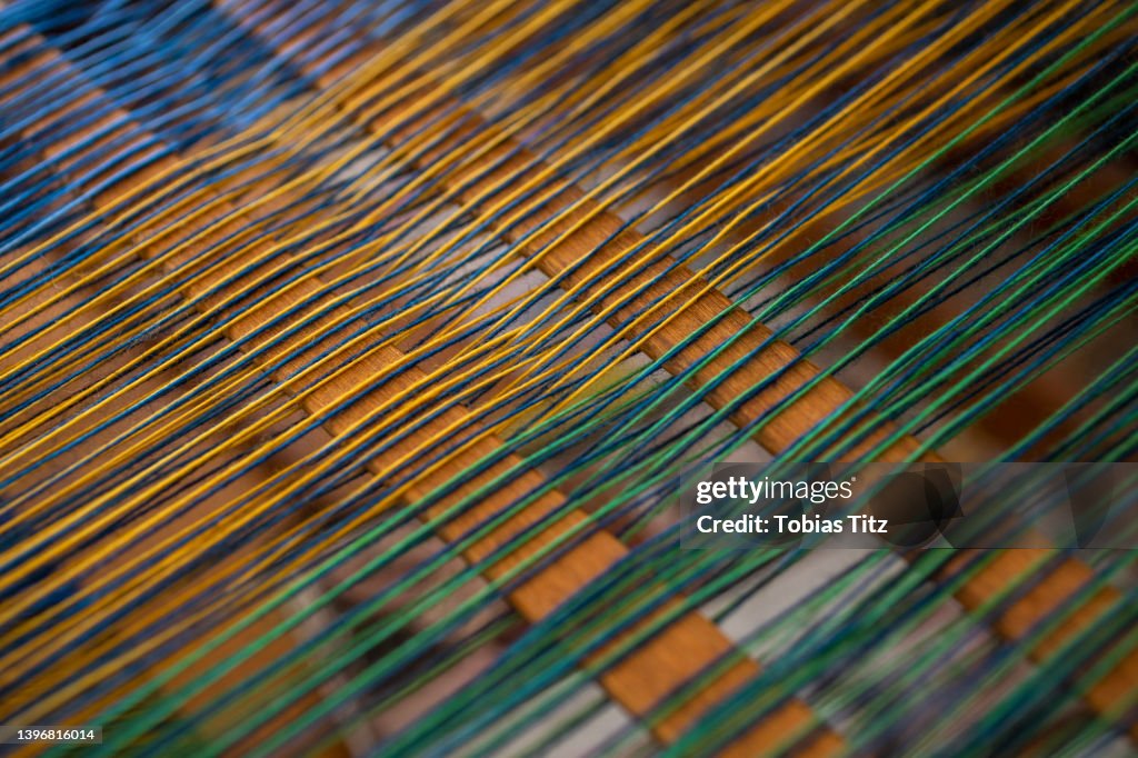 Close up green and yellow thread on loom