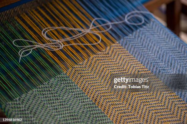 blue, green and orange thread on loom - loom stock pictures, royalty-free photos & images