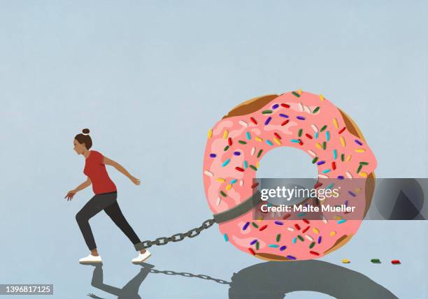 large sprinkled donut chained to let of woman trying to walk - körperbewusstsein stock-grafiken, -clipart, -cartoons und -symbole