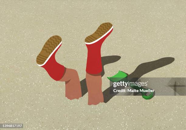 legs with rubber boots buried in sunny sand on beach - den kopf in den sand stecken stock-grafiken, -clipart, -cartoons und -symbole