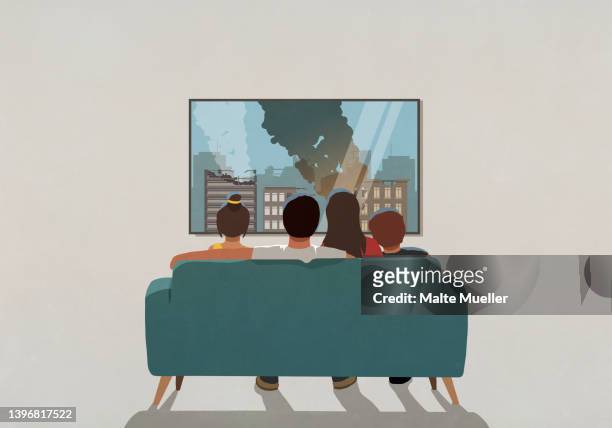 family watching war bombing destruction on television news in living room at home - familie sofa stock-grafiken, -clipart, -cartoons und -symbole