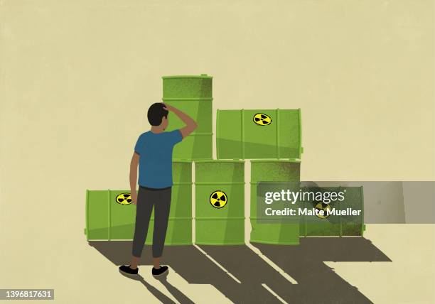 confused man looking at biohazard oil drums - confusion stock illustrations