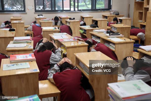 Middle school students attend an emergency evacuation drill on China's national day for disaster prevention and relief on May 12, 2022 in Nantong,...