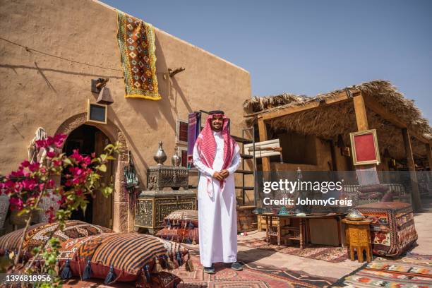 saudi merchant standing outdoors with products for sale - saudi arabian culture stock pictures, royalty-free photos & images