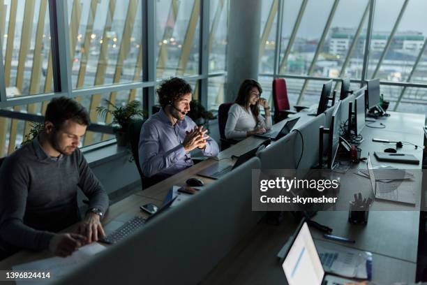 business people working on laptops in a call center. - callcenter stock pictures, royalty-free photos & images
