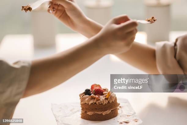 lesbian couples eat cakes in restaurants - date night stock pictures, royalty-free photos & images