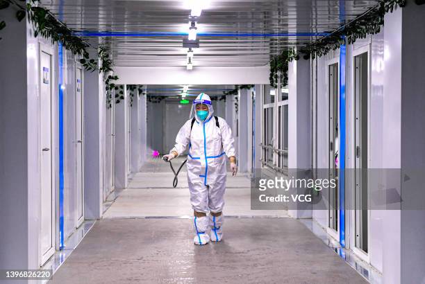 Worker sprays disinfectant at a makeshift hospital in Shenyang International Exhibition Center on May 11, 2022 in Shenyang, Liaoning Province of...
