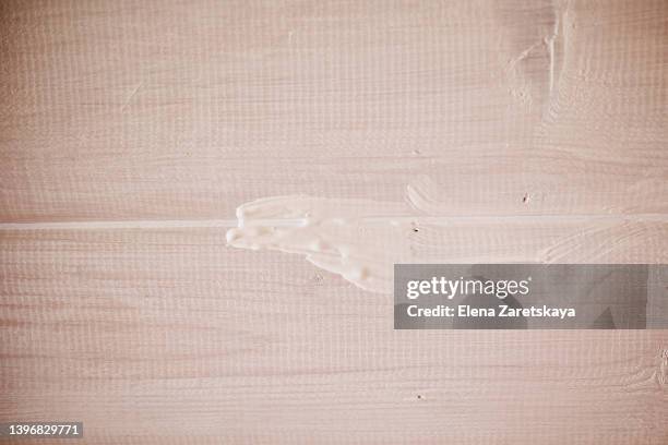 smear of paint on a wooden background - deckenverkleidung holz stock-fotos und bilder