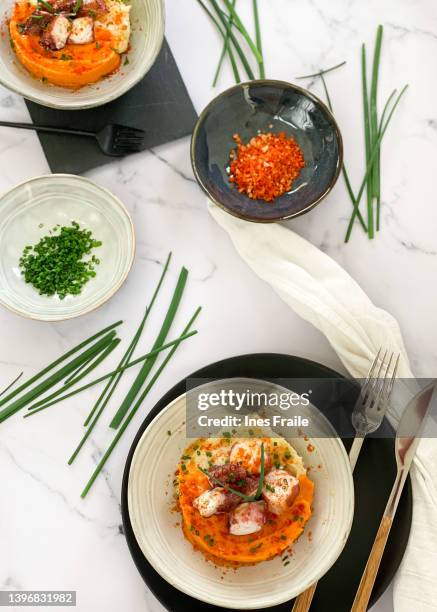 background with plate of octopus and mashed sweet potato - mashed sweet potato imagens e fotografias de stock