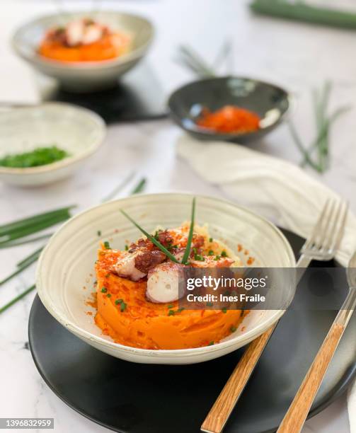 background with plate of octopus and mashed sweet potato - mashed sweet potato imagens e fotografias de stock