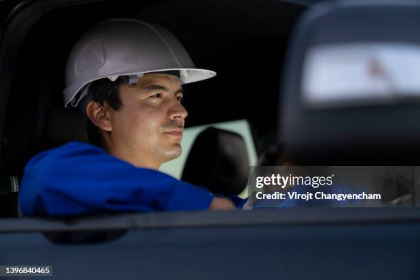 smart engineer driving car at industrial plant at night - 東南アジア ストックフォトと画像