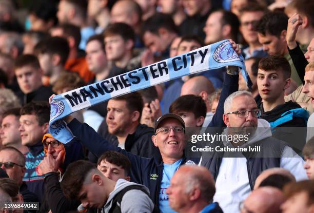 Fan of Manchester City holds up a scarf during the Premier League match between Wolverhampton Wanderers and Manchester City at Molineux on May 11,...