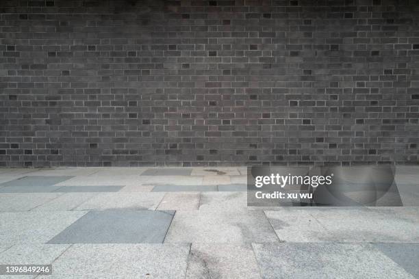 marble floor in front of grey brick wall - mud floor stock pictures, royalty-free photos & images