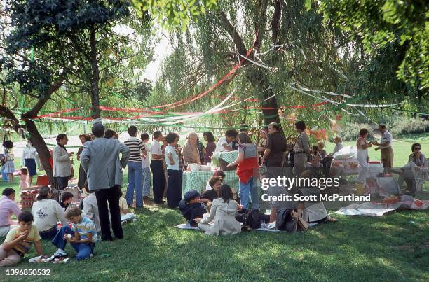 View of people picnicking on the lawn in Flushing Meadows Park, in the Corona neighborhood of Queens, New York, New York, October 1978.