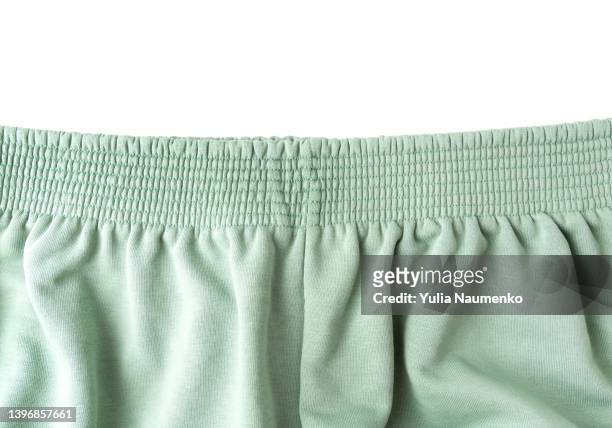 green pants elastic waistband on white background. - bragas fotografías e imágenes de stock
