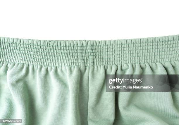 green pants elastic waistband on white background. - pantaloni di tuta foto e immagini stock