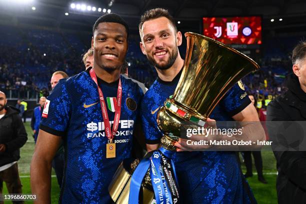 Denzel Dumfries of FC Internazionale and Stefan De Vrij of FC Internazionale celebrate with the trophy after winning the oppa Italia Final match...