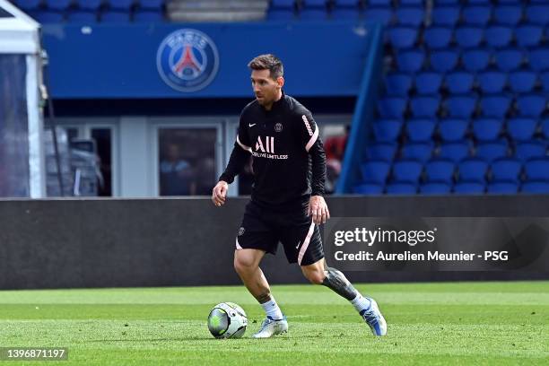 Leo Messi runs with the ball during a Paris Saint-Germain training session at Parc des Princes on May 12, 2022 in Paris, France.