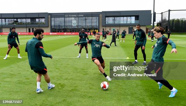 Mohamed Salah, Thiago Alcantara and Kostas Tsimikas of Liverpool during a training session at AXA Training Centre on May 12, 2022 in Kirkby, England.