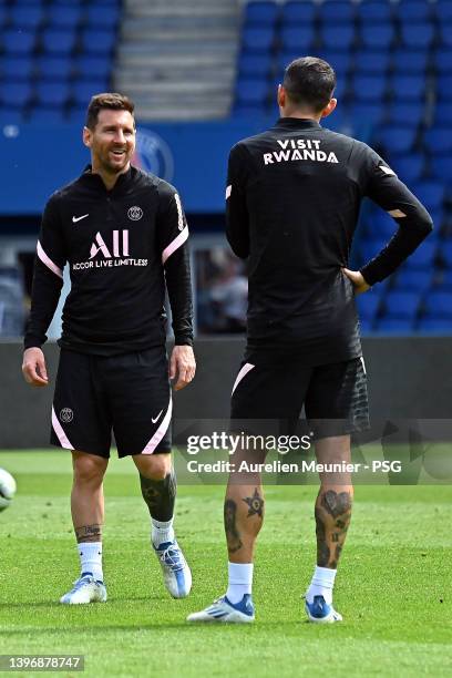 Leo Messi speaks with Angel Di Maria during a Paris Saint-Germain training session at Parc des Princes on May 12, 2022 in Paris, France.