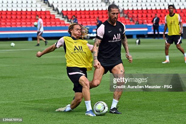 Sergio Ramos and Xavi Simons fight for possession during a Paris Saint-Germain training session at Parc des Princes on May 12, 2022 in Paris, France.